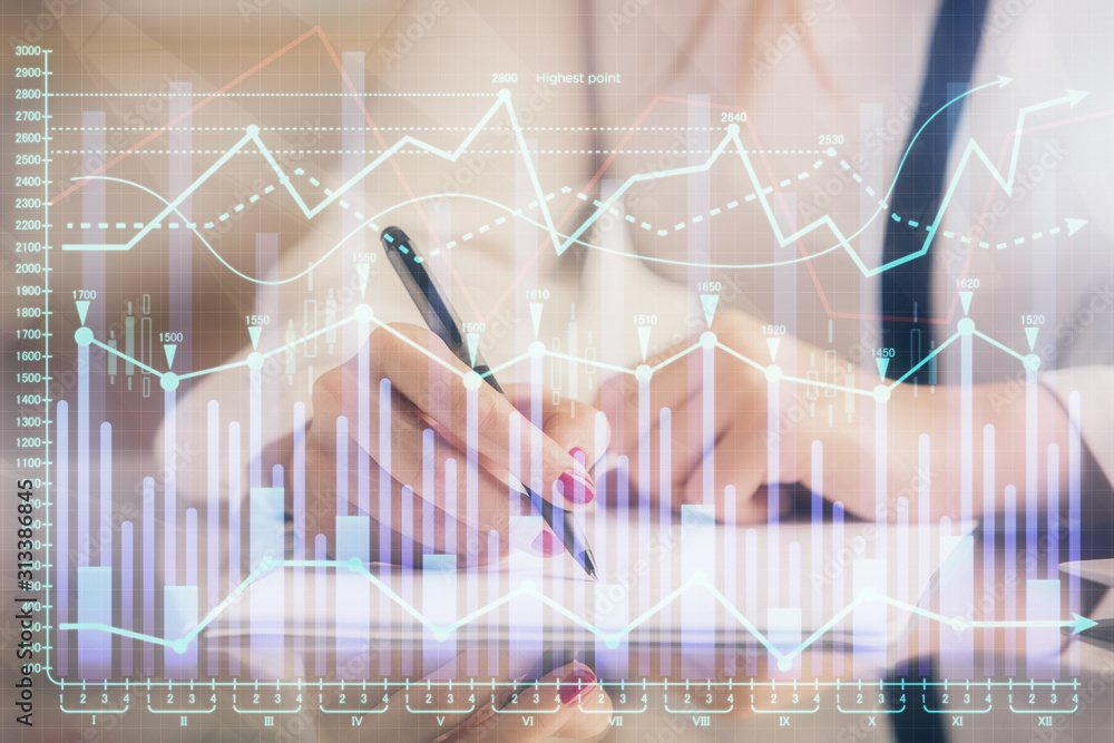 Double exposure of hands making notes with forex chart huds. Stock market concept. Double exposure of hands making notes with forex chart huds. Stock market concept.