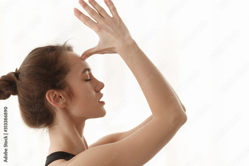 Woman doing namaste gesture, hands to forehead Woman doing namaste gesture, hands to forehead