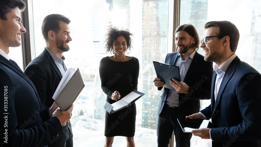 Happy diverse colleagues have fun brainstorming in office Happy diverse colleagues have fun brainstorming in office