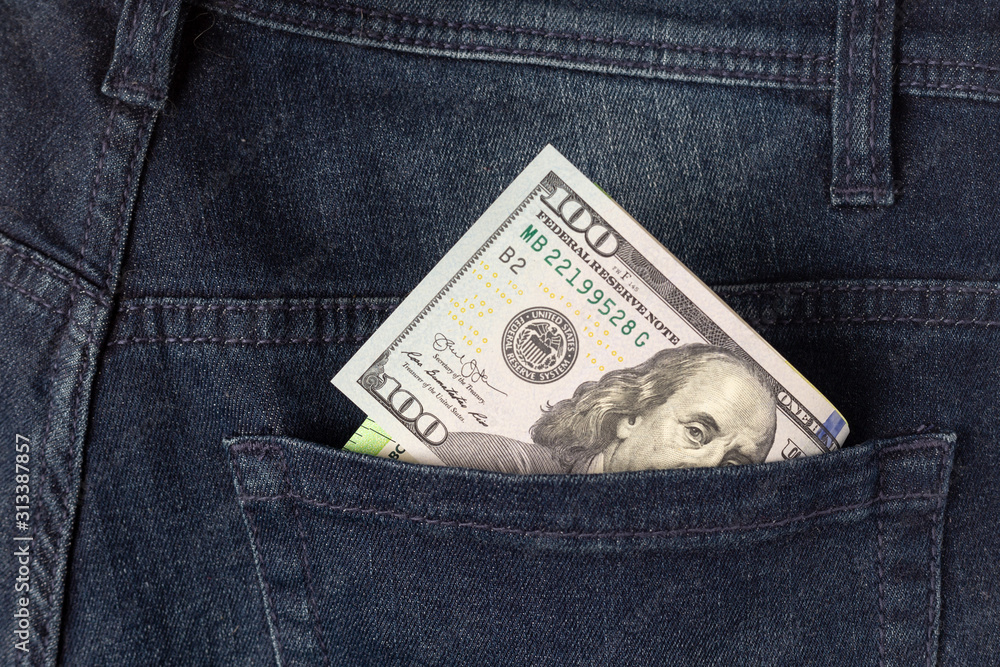 One hundreds dollars in a back pocket of trousers One hundreds dollars in a back pocket of trousers