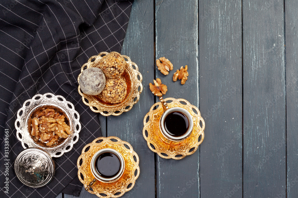 Nut balls dessert served with coffee on dark wooden table, top view Nut balls dessert served with coffee on dark wooden table, top view