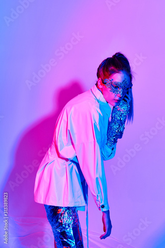girl in beautiful modern clothes posing in the Studio with objects, mannequin