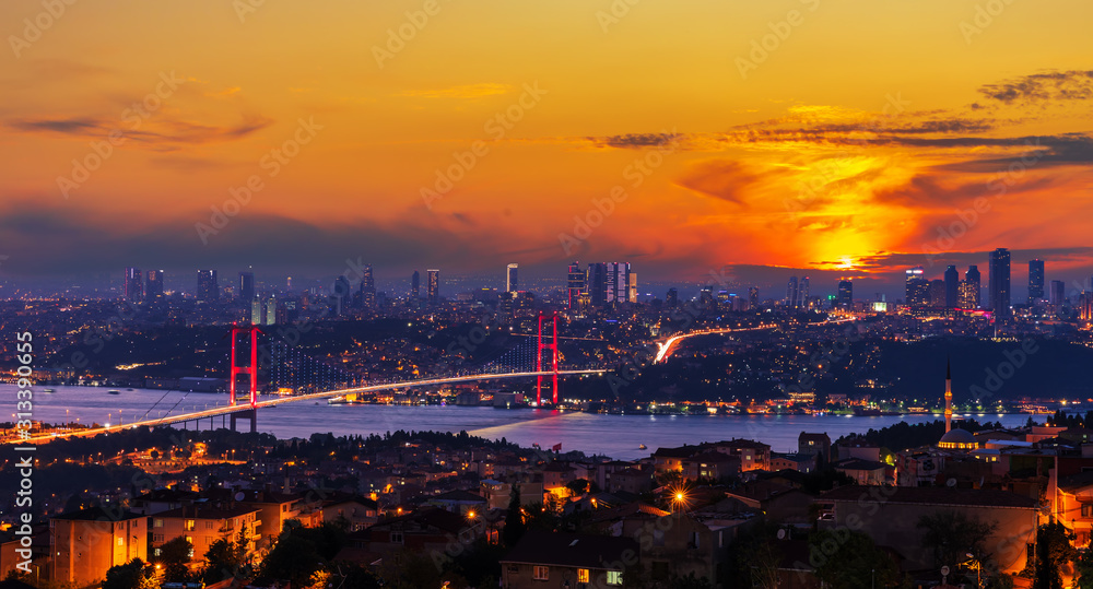 Fototapeta premium Bright sunset and the Boshporus Bridge in Istanbul, view from the Asian side, Turkey