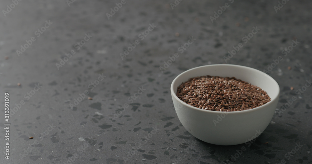 flaxseed in white bowl on terrazzo countertop with copy space flaxseed in white bowl on terrazzo countertop with copy space