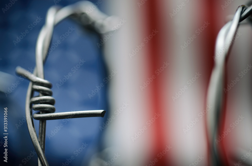 Barbed wire and United States of America flag , immigration stock photo. - obrazy, fototapety, plakaty 