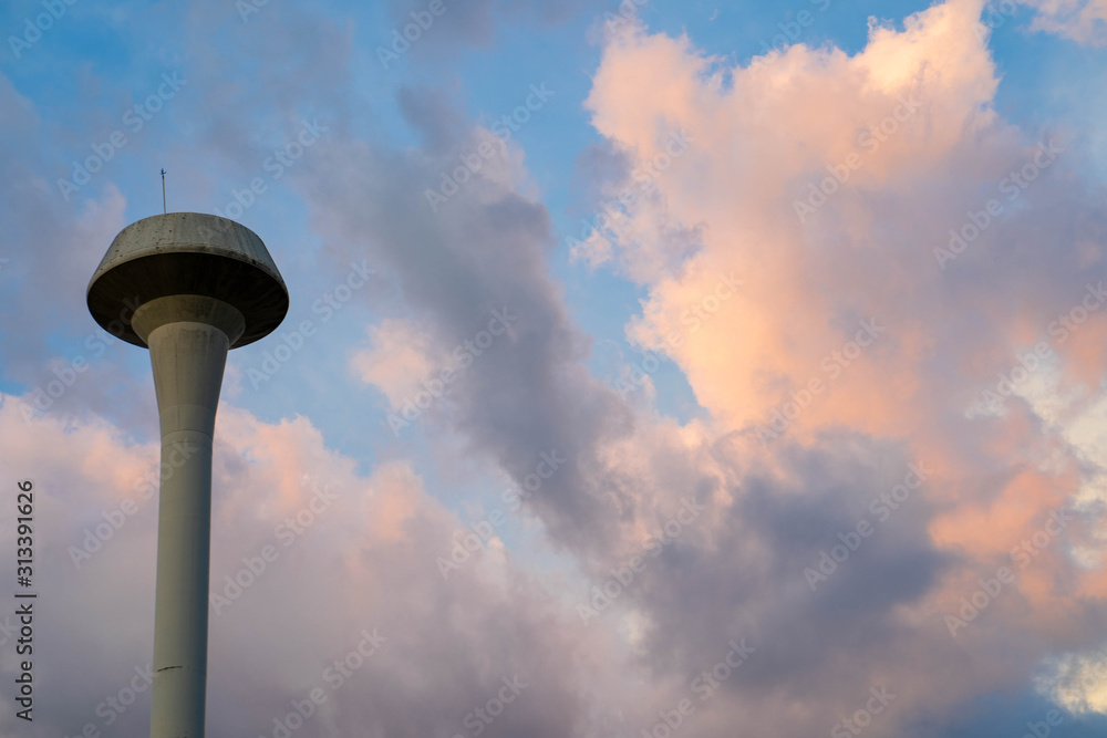 Elevated Water Tank against sunset sky.