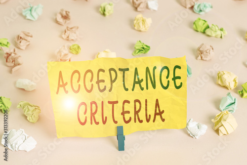 Handwriting text writing Acceptance Criteria. Conceptual photo Specified indicators in assessing the ability of a part Colored crumpled papers empty reminder pink floor background clothespin © Artur