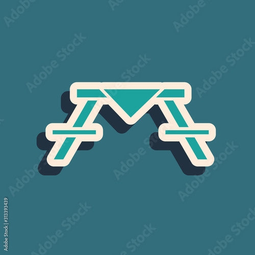 Green Picnic table with benches on either side of the table icon isolated on blue background. Long shadow style. Vector Illustration