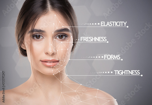 Young pretty lady with skin featers marks over grey background photo