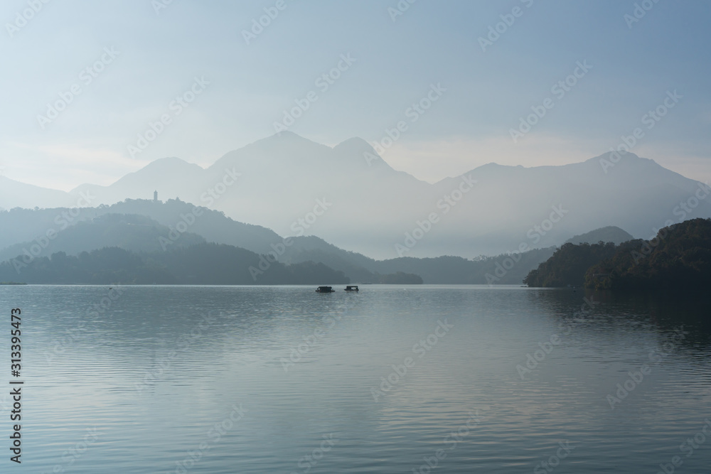 Mountains in lake with morning fog