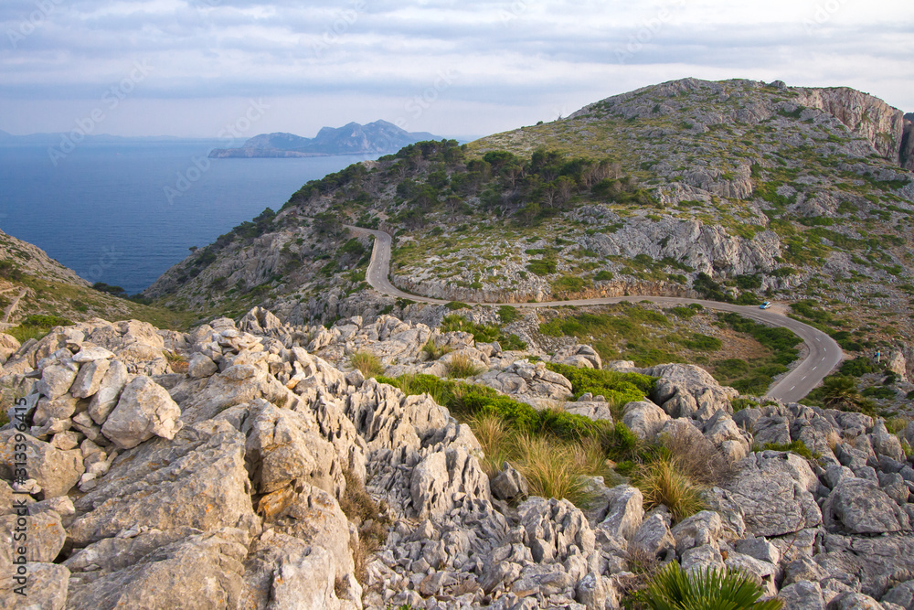 Summer Balearic landscape with beautiful rocks and sea. Beautiful mountain road, mountain serpentine. Mallorca - Cap de Formentor.