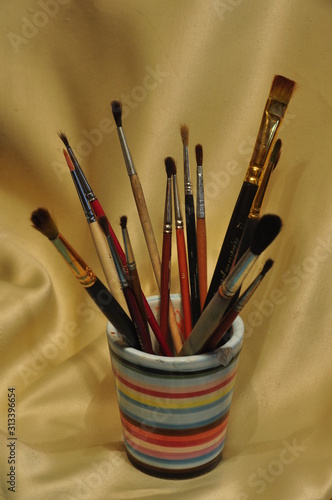 paint brushes on yellow background