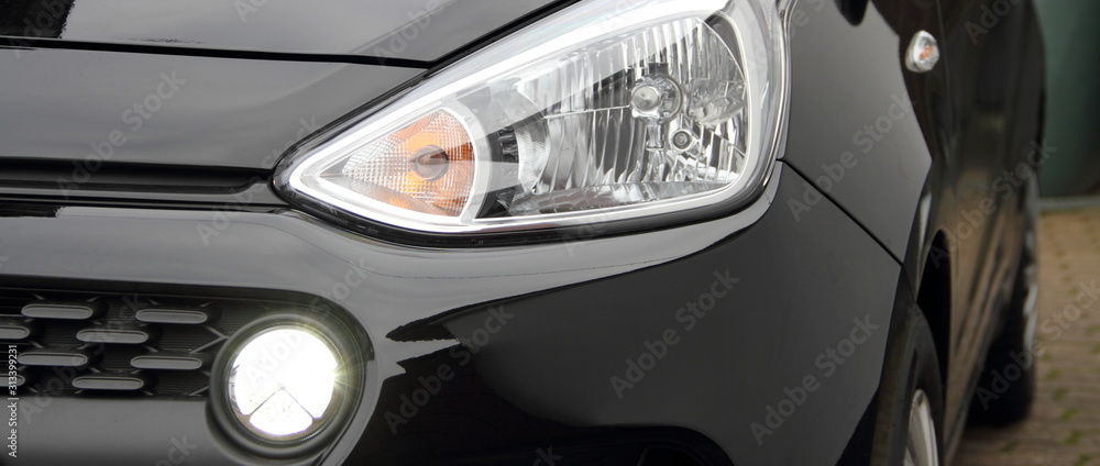 a modern car headlight with daytime running lights on a car