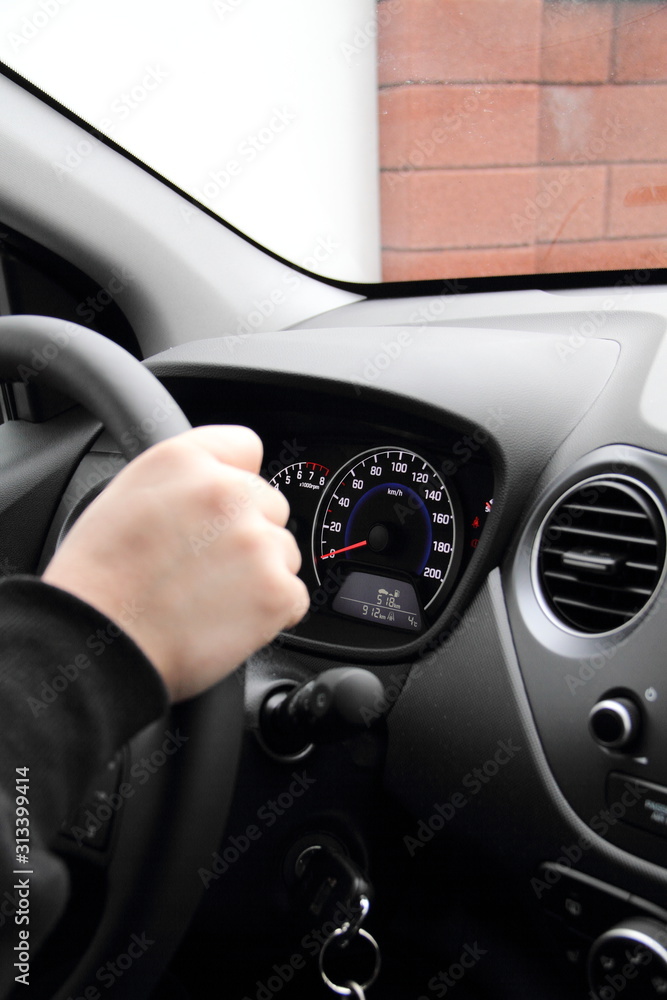 a modern dashboard in a car with a driver behind the wheel