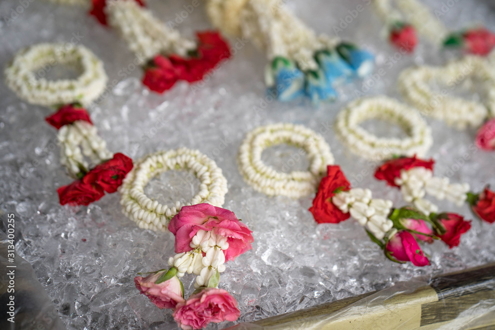 Beautiful garland on ice cubes are for sale at market in Thailand
