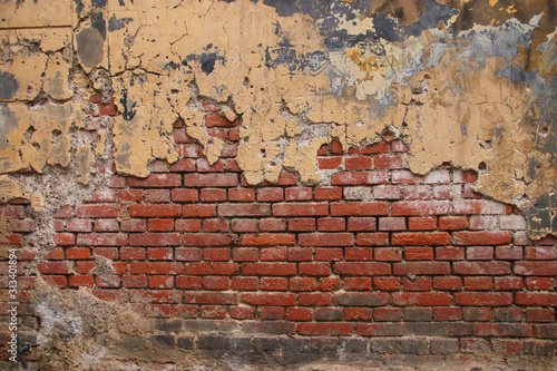 Background of old brick wall with peeling plaster
