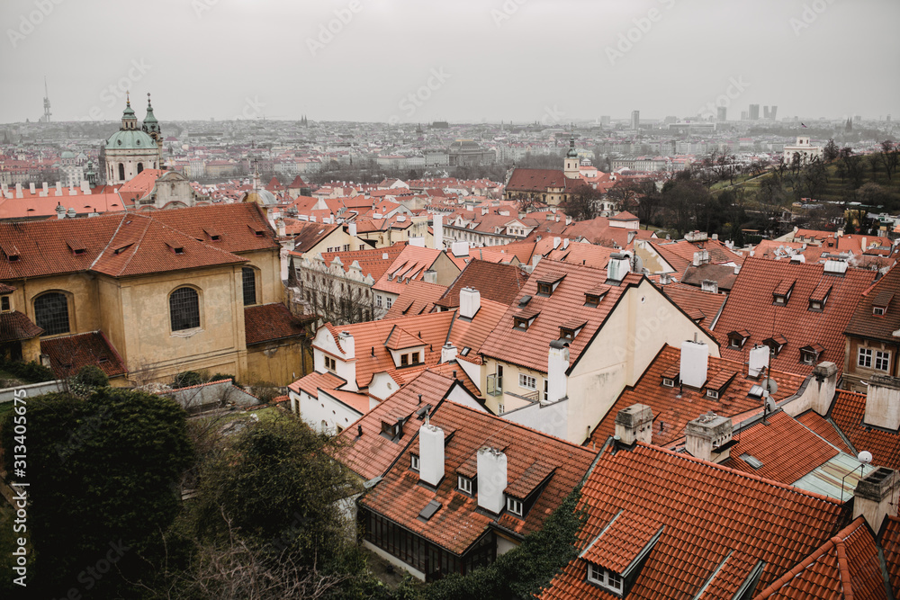 Panorama of Prague with red roofs and Church. City view of Praha old city. Rustic grey colors toning. Panorama of Prague with red roofs and Church. City view of Praha old city. Rustic grey colors toning.
