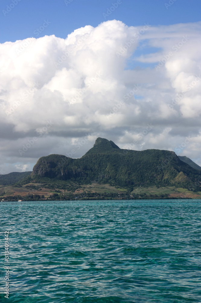 Turquois, crystal clear water at a lagoon near Mahebourg, Mauritius with volcanic landscape in the background Turquois, crystal clear water at a lagoon near Mahebourg, Mauritius with volcanic landscape in the background