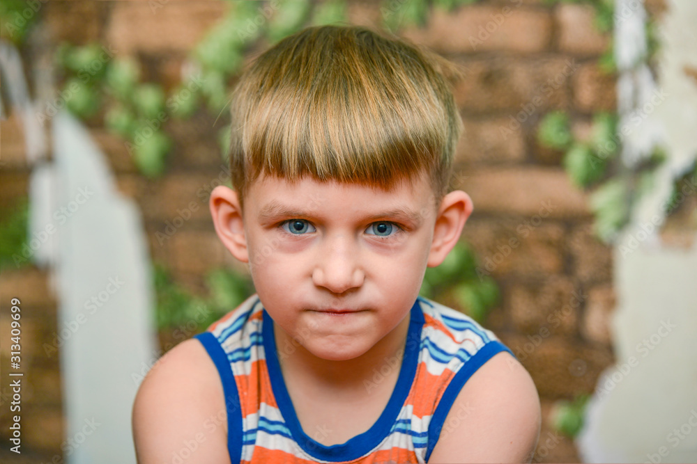 A small child is standing near an old brick wall. A small child is standing near an old brick wall.