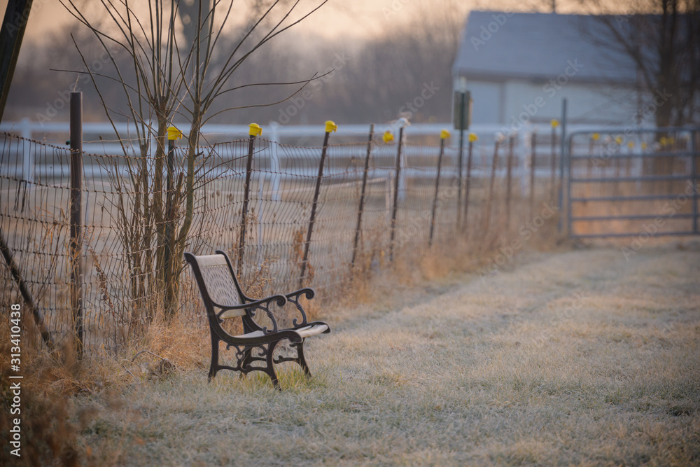 Park Bench out in a farm field on a chilly morning