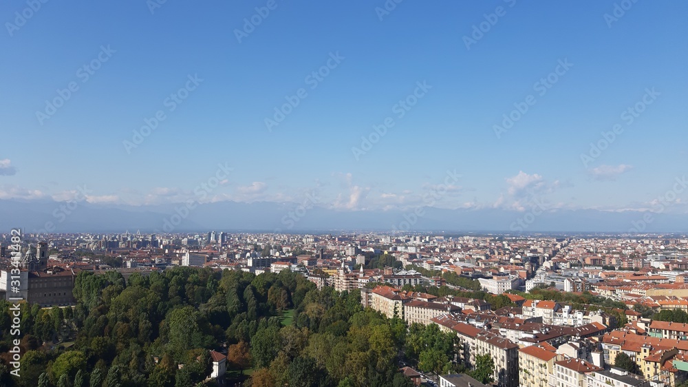 Fototapeta premium Turin, Italy - 01/004/2019: Beautiful panoramic view from Mole Antoneliana to the city of Turin in winter days with clear blue sky and the alps in the background. 