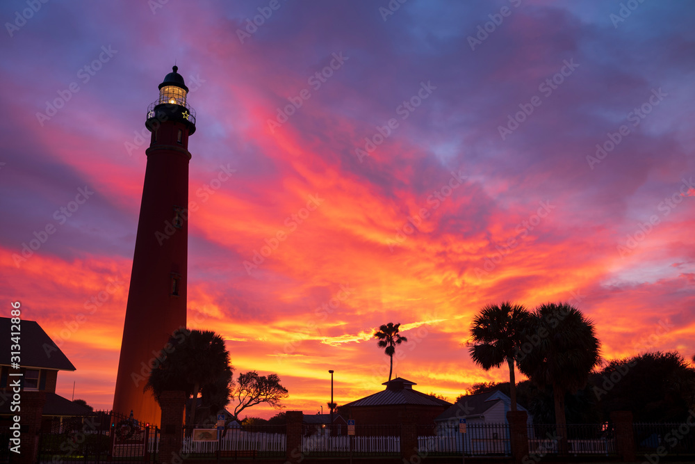 The Ponce de Leon Inlet Light, a lighthouse and museum located near Daytona Beach in central Florida, glows during a morning sunrise. At 175 feet in height, it is the tallest lighthouse in the state 