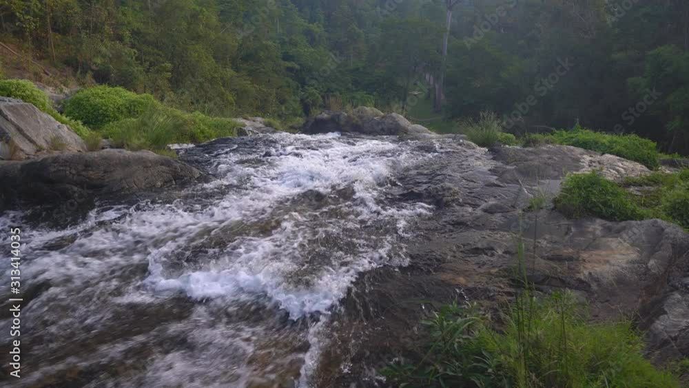 stream waterfall with rock and tree in green jungle or forest with camping tent on holiday relax and vacation travel trekking and picnic on lawn or grass at Khlong Nam Lai Waterfall 4K nature sound stream waterfall with rock and tree in green jungle or forest with camping tent on holiday relax and vacation travel trekking and picnic on lawn or grass at Khlong Nam Lai Waterfall 4K nature sound