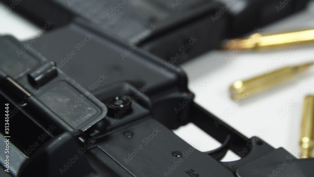 Close Up Automatic Sniper Rifle On Table With Bullets. Track Right Shot Close Up Automatic Sniper Rifle On Table With Bullets. Track Right Shot