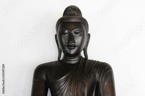 The black meditating Buddha statue © Wootipong