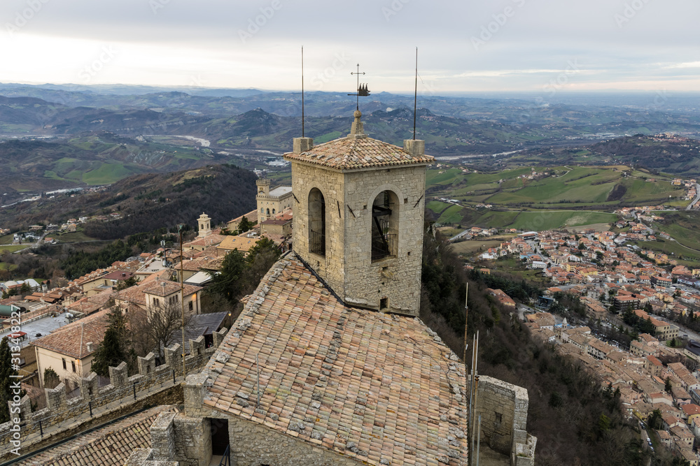 First fortress in San Marino (Guaita or Rocca), bell tower and city of San Marino view - Image