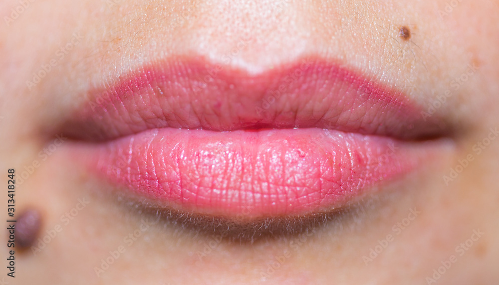 Fototapeta premium beautiful, female, red lips and mole close-up