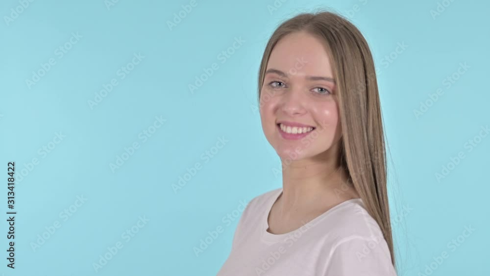 Beautiful Young Woman Turn Around and Smile, Blue Background Beautiful Young Woman Turn Around and Smile, Blue Background