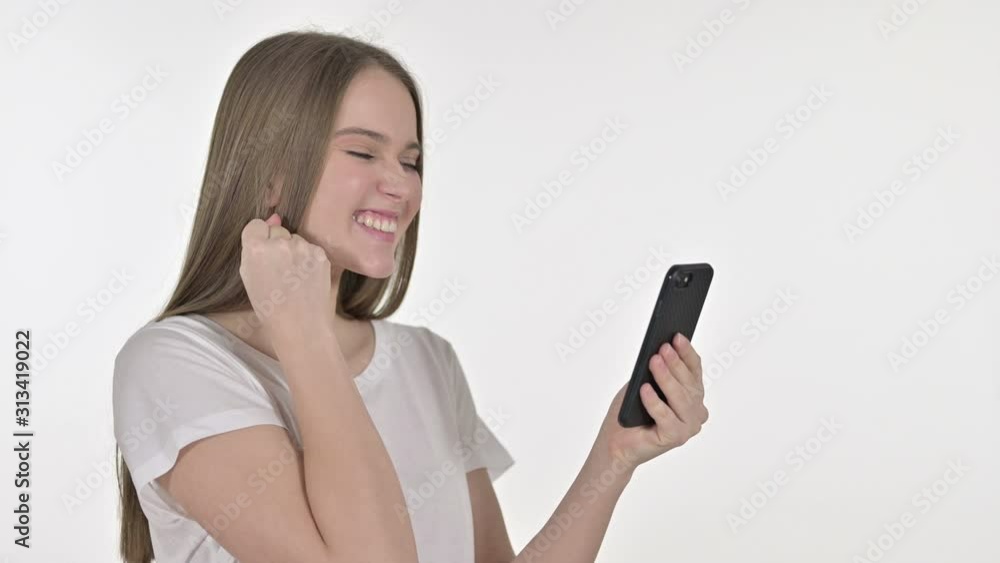 Beautiful Young Woman Celebrating on Smartphone, White Background Beautiful Young Woman Celebrating on Smartphone, White Background