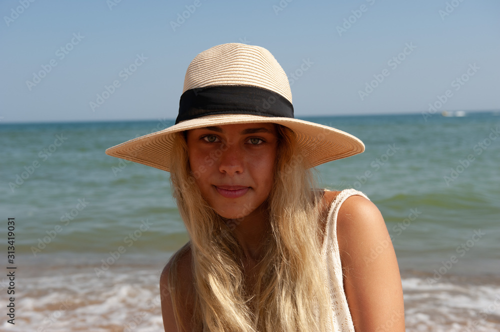 Girl in a hat near the sea