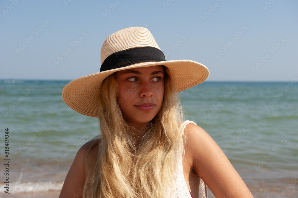 Girl in a hat near the sea