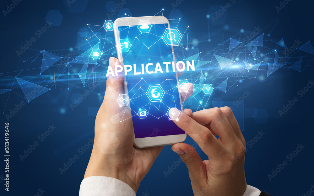 Female hand holding smartphone with APPLICATION inscription, modern technology concept Female hand holding smartphone with APPLICATION inscription, modern technology concept