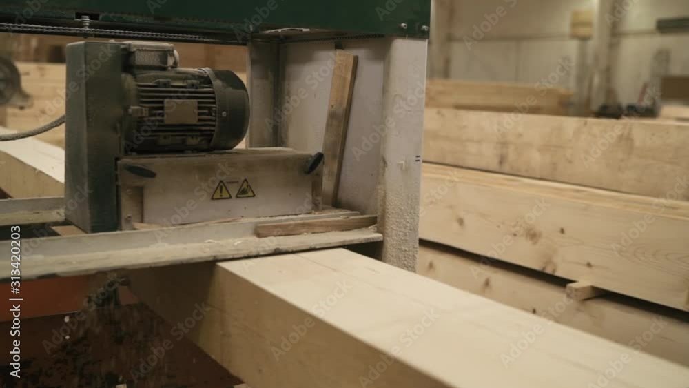 close up worker gives the desired shape to a wooden planer machine, construction of wooden houses close up worker gives the desired shape to a wooden planer machine, construction of wooden houses