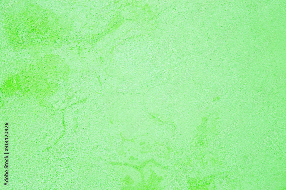Old peeling paint on the wall. Green abstract background. Beautiful green textured stucco on the wall. Background from green stucco.