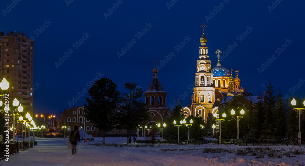 View of the Orthodox Church of the night city. Panorama of night lights of the city