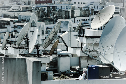 Old fashioned picture using a filter of satellite dishes on a roof of a tall building in Casablanca, Morocco