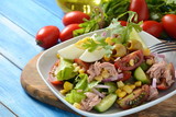 Tuna salad with lettuce, eggs and tomatoes, cucumber, corn and red onion. Healthy Mediterranean food concept