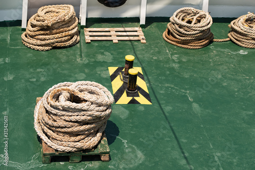 Rope teirs on the green sea vessel deck photo