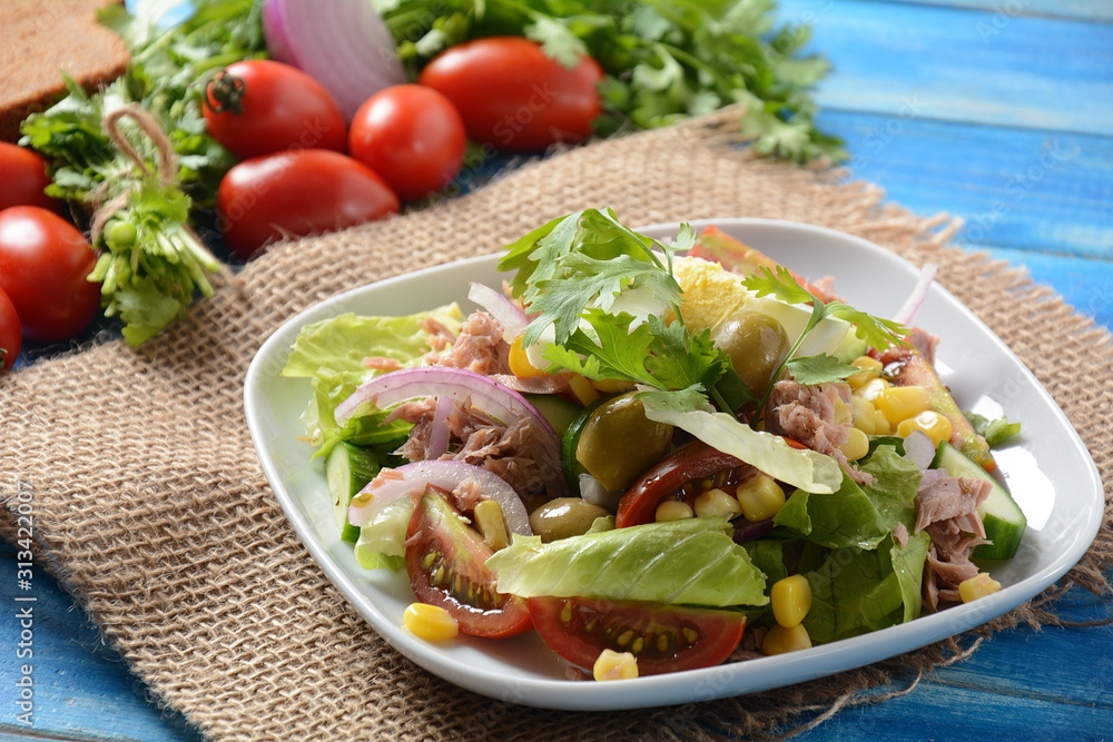 Tuna salad with lettuce, eggs and tomatoes, cucumber, corn and red onion. Healthy Mediterranean food concept Tuna salad with lettuce, eggs and tomatoes, cucumber, corn and red onion. Healthy Mediterranean food concept