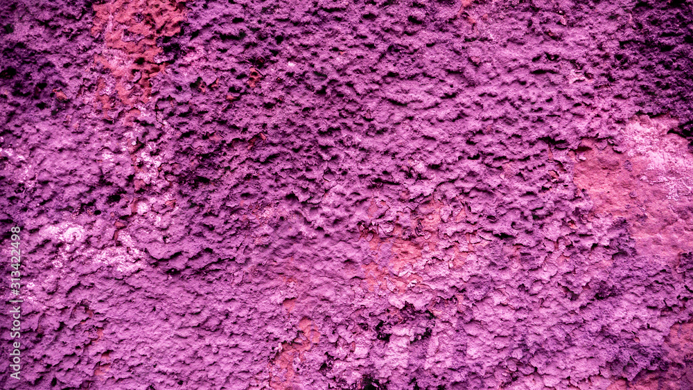 Old peeling paint on the wall..Purple abstract background. Beautiful purple textured stucco on the wall. Background from purple stucco.