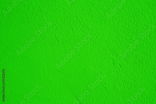 Old peeling paint on the wall..Green abstract background..Beautiful green textured stucco on the wall..Background from green stucco.