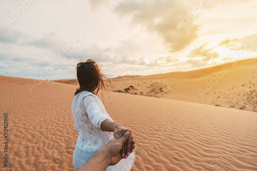 Young couple traveler looking beautiful landscape at red sand dunes in Vietnam, Travel lifestyle concept