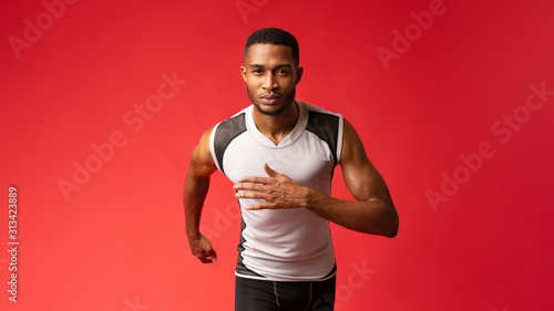 Plakat Serious afro guy running at camera at studio
