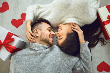 Valentine's day. Couple gives heart to the Valentine's Day in the room. Top view