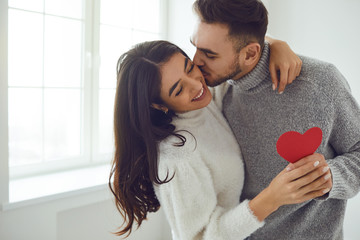 Valentine's day. Couple gives heart to the Valentine's Day in the room.