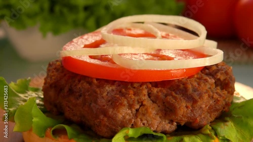 Cesam bun falls on the table. Prepared products for hamburgers on the table  photo